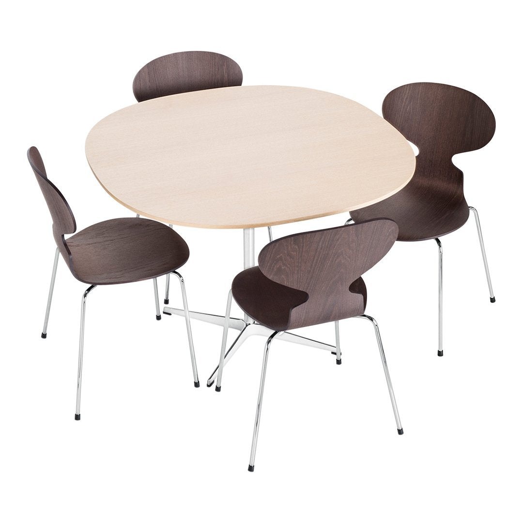 Light wood oval table with four dark brown chairs, featuring smooth, minimalist design. Modern home dining set.