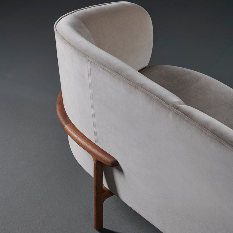 Soft beige upholstery with a smooth texture, complemented by a warm wooden frame. Modern and elegant design.