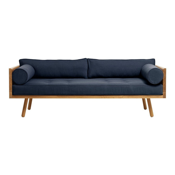 Navy blue sofa with a sleek design, featuring solid wood arms and cylindrical cushions. Perfect for modern interiors.
