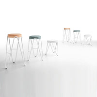 Colorful modern stools in white, mint green, and light orange with sleek white metal frames.