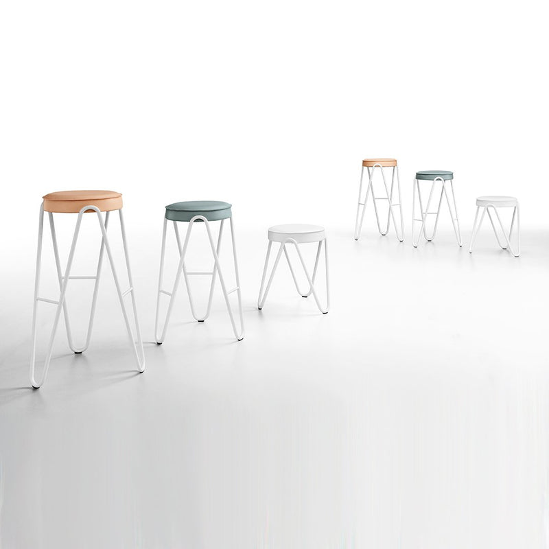 Colorful modern bar stools in shades of orange, teal, white, and light gray with minimalistic white legs.
