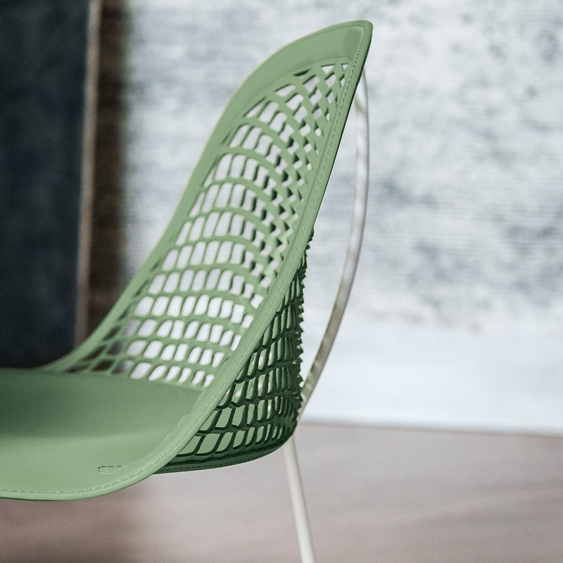 Modern green chair with a unique mesh pattern and sleek transparent legs, perfect for contemporary decor.