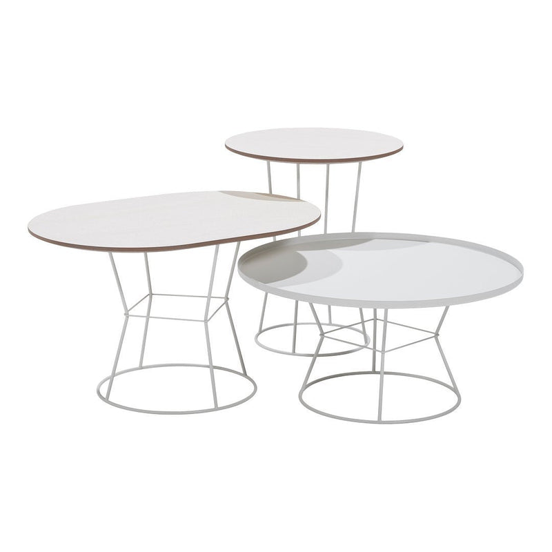 Three modern tables featuring white tops with smooth surfaces and elegant wire legs in a minimalist design.