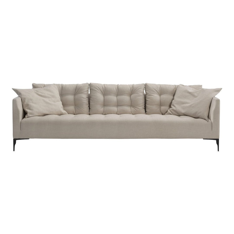 Beige tufted sofa with soft cushions and sleek black legs, featuring a modern, minimalist design.