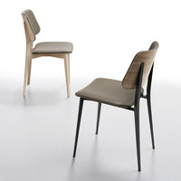 Two modern chairs, one natural wood and beige, the other black with a beige cushion, showcasing sleek, minimalist design.