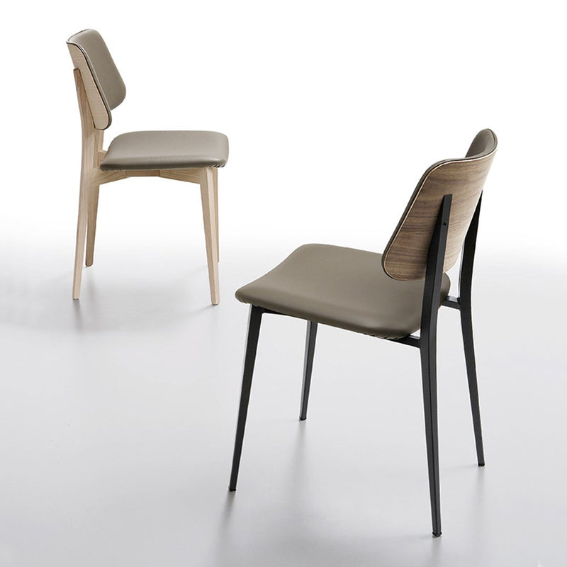 Two modern chairs featuring a light wood frame and a dark, sleek metal base with neutral beige upholstery.