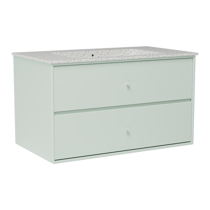 Light mint green dresser with a speckled white countertop and minimalist design. Perfect for modern interiors.