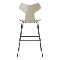 Cream-colored modern bar stool with a sleek black metal frame and minimalistic design. Ideal for contemporary spaces.