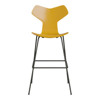 Yellow modern bar stool with a unique curved design and sleek black metal legs. Stylish and contemporary.