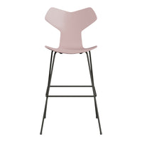 Pink modern bar stool with sleek black metal legs, featuring a smooth, minimalist design and unique shape.