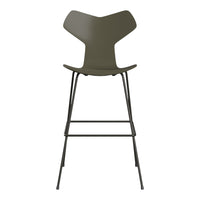 Olive green chair with a unique backrest design and sleek black metal legs, perfect for modern interiors.
