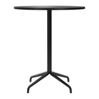 Black round tabletop with a sleek, minimalist design and a sturdy black metal base featuring a classic four-legged support.