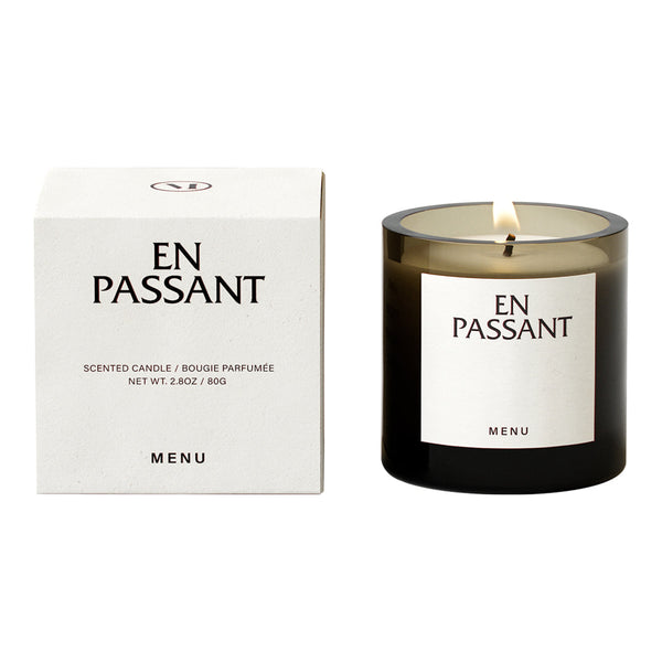 Black and white scented candle with elegant packaging and minimalistic design, featuring subtle smoky tones.