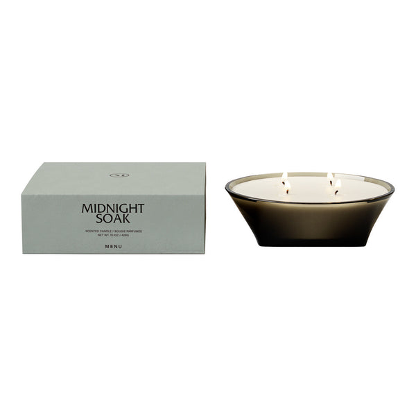 Sleek black candle with three wicks, paired with a soft green box featuring elegant typography.