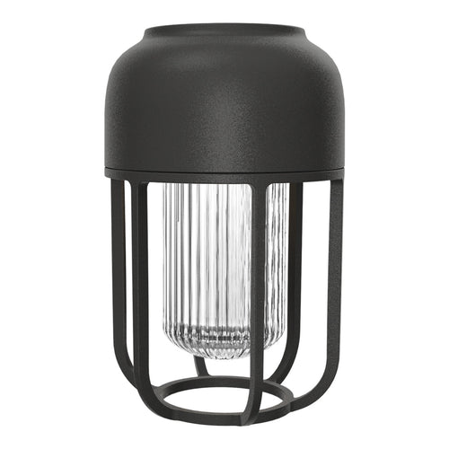 Black metal lamp with ribbed glass detail, featuring a sleek, modern design and minimalist aesthetic.