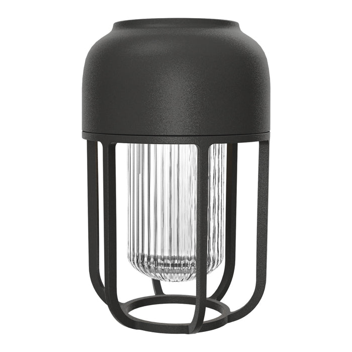 Black metal lamp with ribbed glass detail, featuring a sleek, modern design and minimalist aesthetic.
