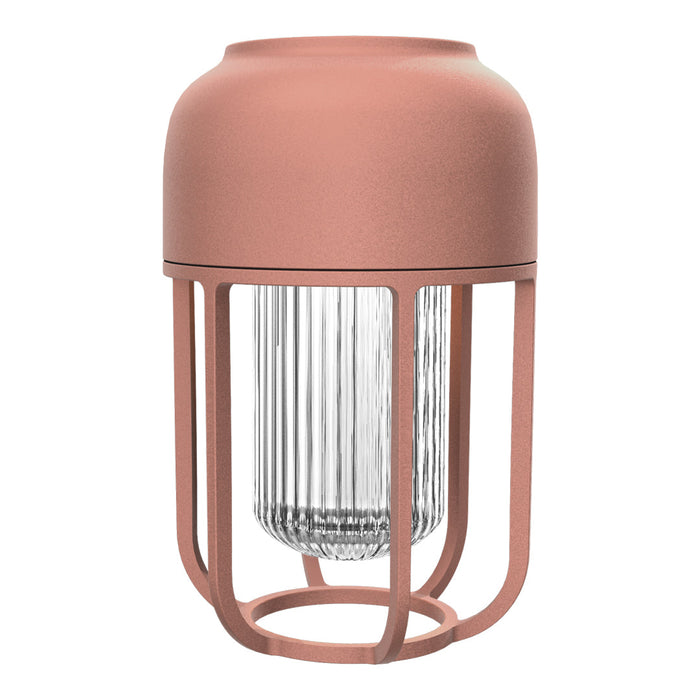 Rose-colored metal lamp with a textured glass shade and sleek, minimalistic design. Ideal for modern decor.