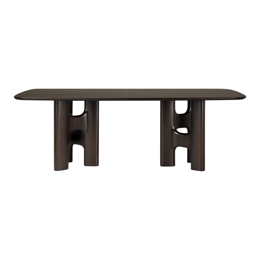 Brown rectangular table with smooth surface and unique cut-out patterns on supporting legs, showcasing modern design.