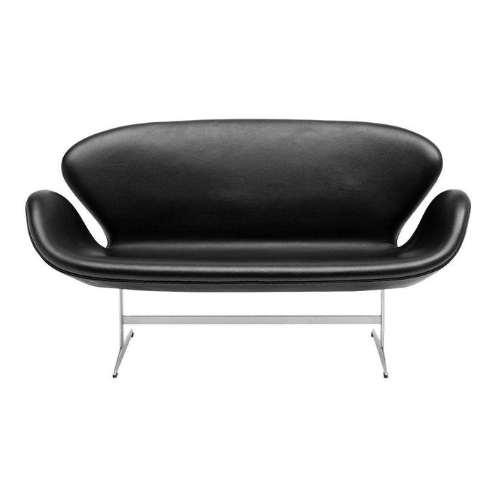 Elegant black leather sofa with smooth curves and minimalist chrome legs for a modern touch. Perfect for any space.