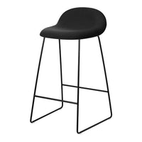 Black bar stool with a sleek, curved seat and minimalist black metal legs. Modern design for contemporary interiors.