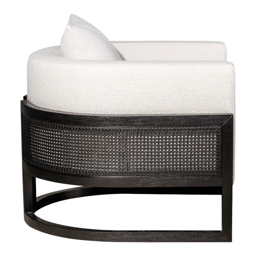 Curved white upholstery with textured black rattan base, showcasing a modern and minimalist design. Perfect for chic interiors.