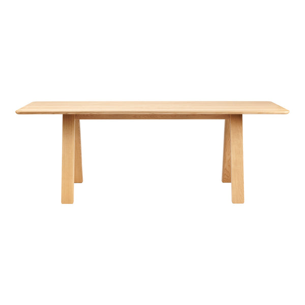 Light natural wood dining table with a smooth finish and minimalist design, featuring clean lines and no visible patterns.