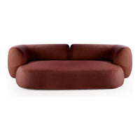 Rust-colored, rounded sofa with a smooth, minimalist design and plush, seamless upholstery without patterns.