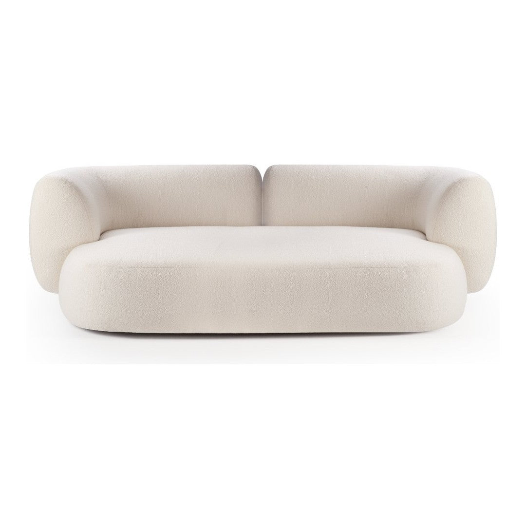 Cream-colored sofa with soft, rounded edges and smooth upholstery, perfect for modern interiors.