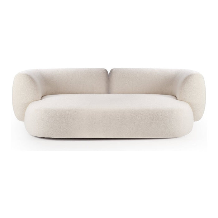 Cream-colored, plush sofa with rounded edges and a smooth, modern fabric texture. Ideal for contemporary decor.