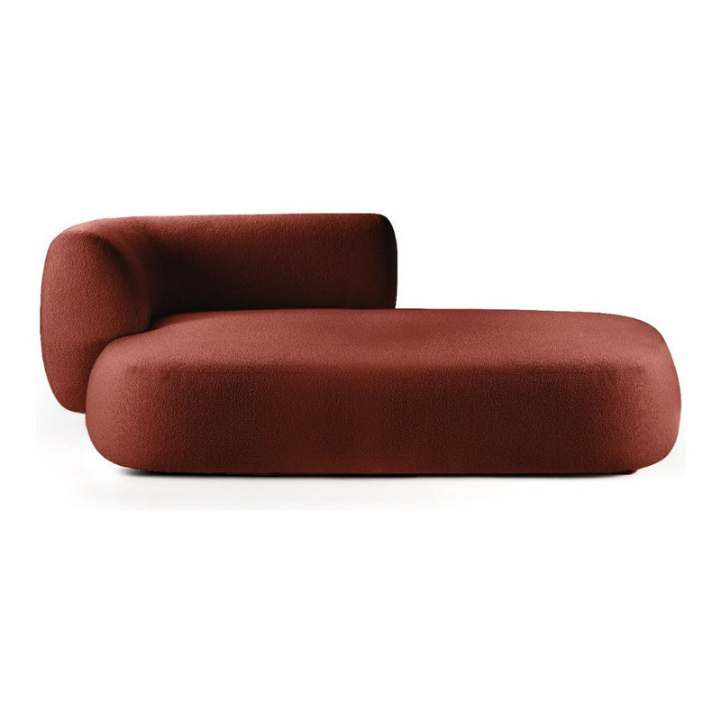 Luxurious rust-colored chaise lounge with a sleek, minimalist design and a smooth, textured fabric finish.
