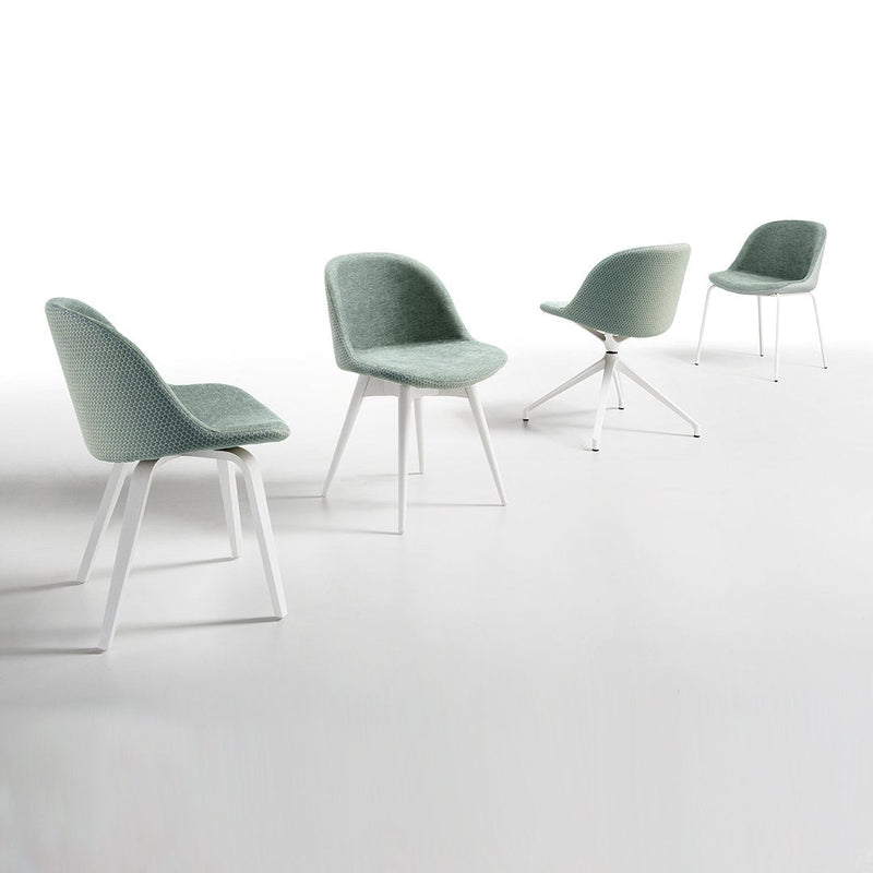 Set of four modern chairs in soft mint green upholstery with white legs, showcasing a sleek and stylish design.