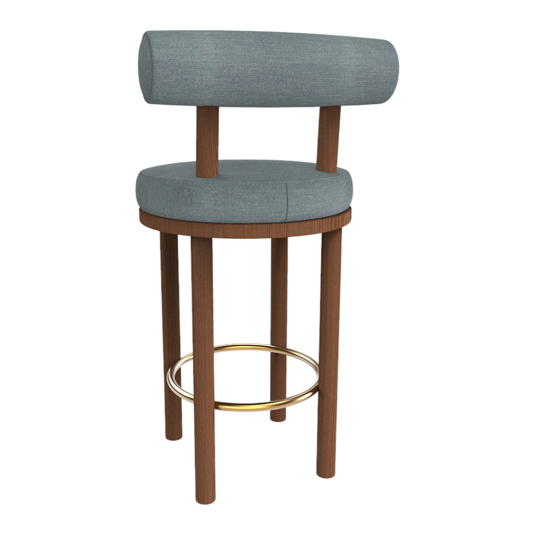 Light blue upholstered bar stool with wooden legs and a gold footrest, featuring a modern, minimalist design.