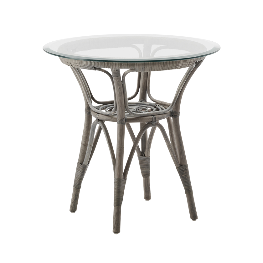 Round rattan table with a natural gray finish and a clear glass top, featuring intricate woven patterns.