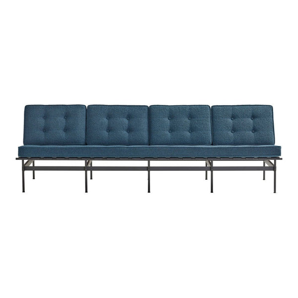 Four-seat sofa in rich navy blue with tufted cushions and a sleek black metal frame.