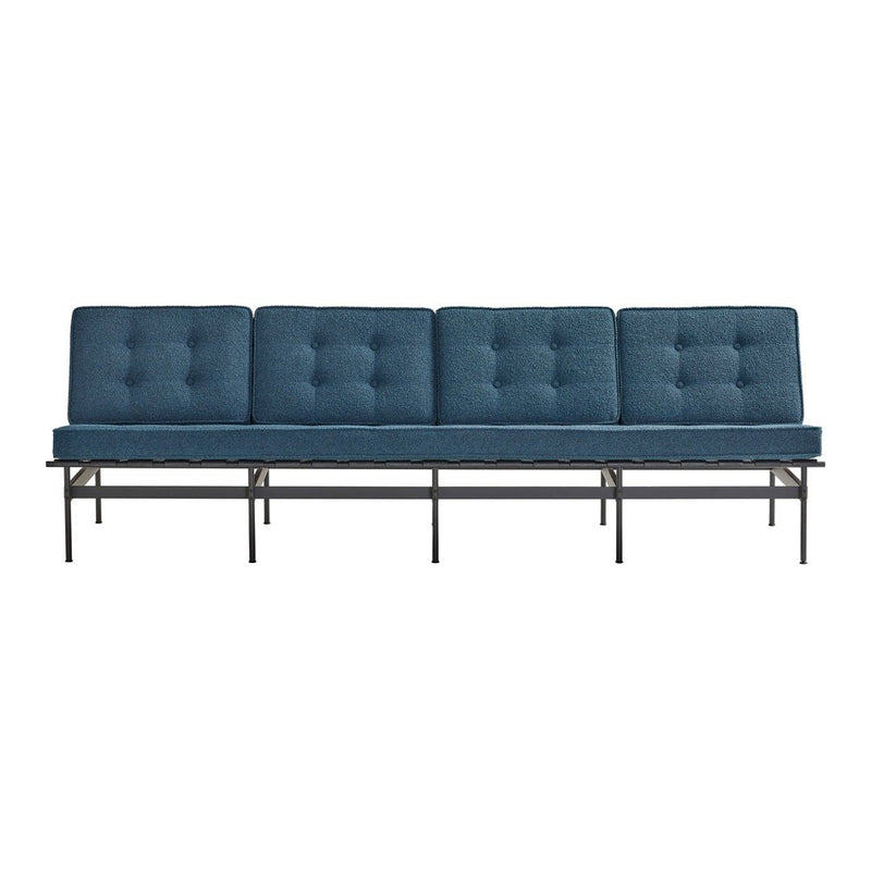 Four-seat sofa in rich navy blue with tufted cushions and a sleek black metal frame.