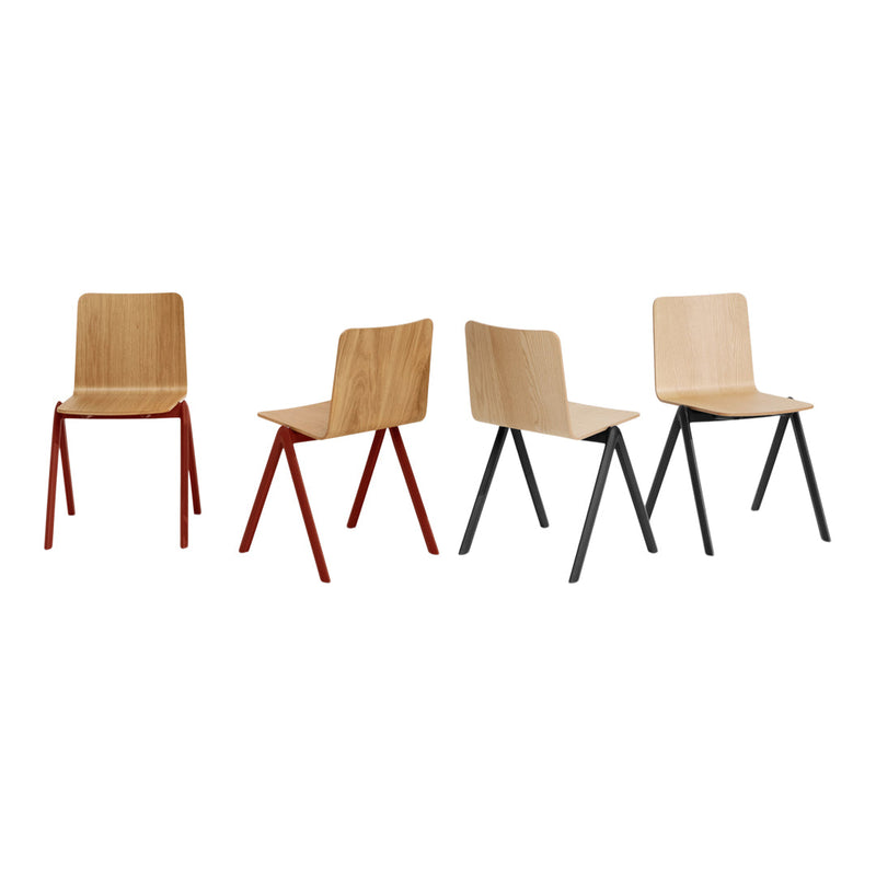 Set of four modern chairs featuring natural wood tones with red and black metal legs. Minimalist, contemporary design.
