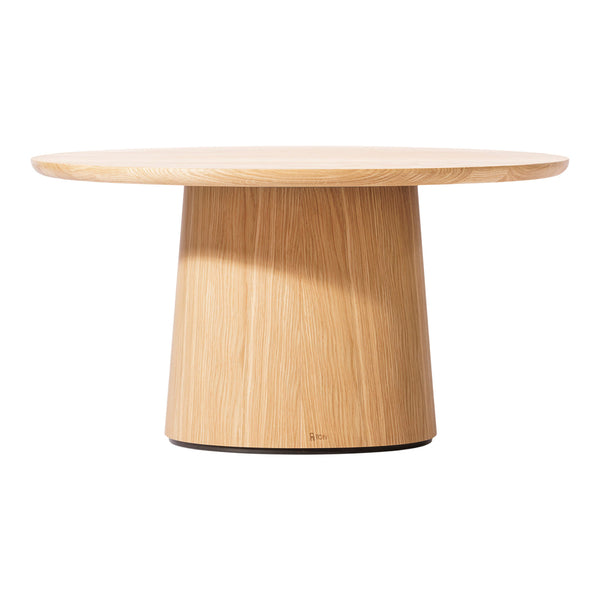 Lightly grained natural wood coffee table with a seamless round top and cylindrical base in warm oak tones.