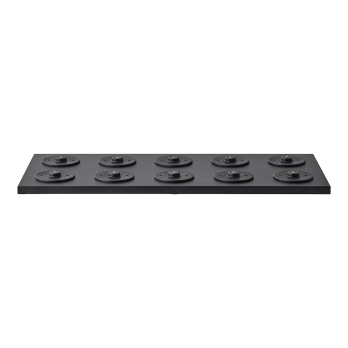 Black rectangular weight plate with smooth surface and circular pattern on top, featuring ten evenly spaced discs.