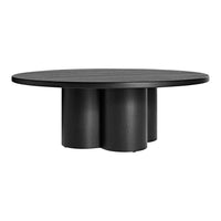 Round black coffee table with a smooth surface and unique three-column base design, adding a modern touch.