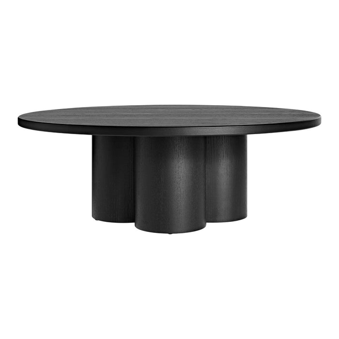 Round black table with a smooth surface and cylindrical pedestal base, showcasing a minimalist modern design.