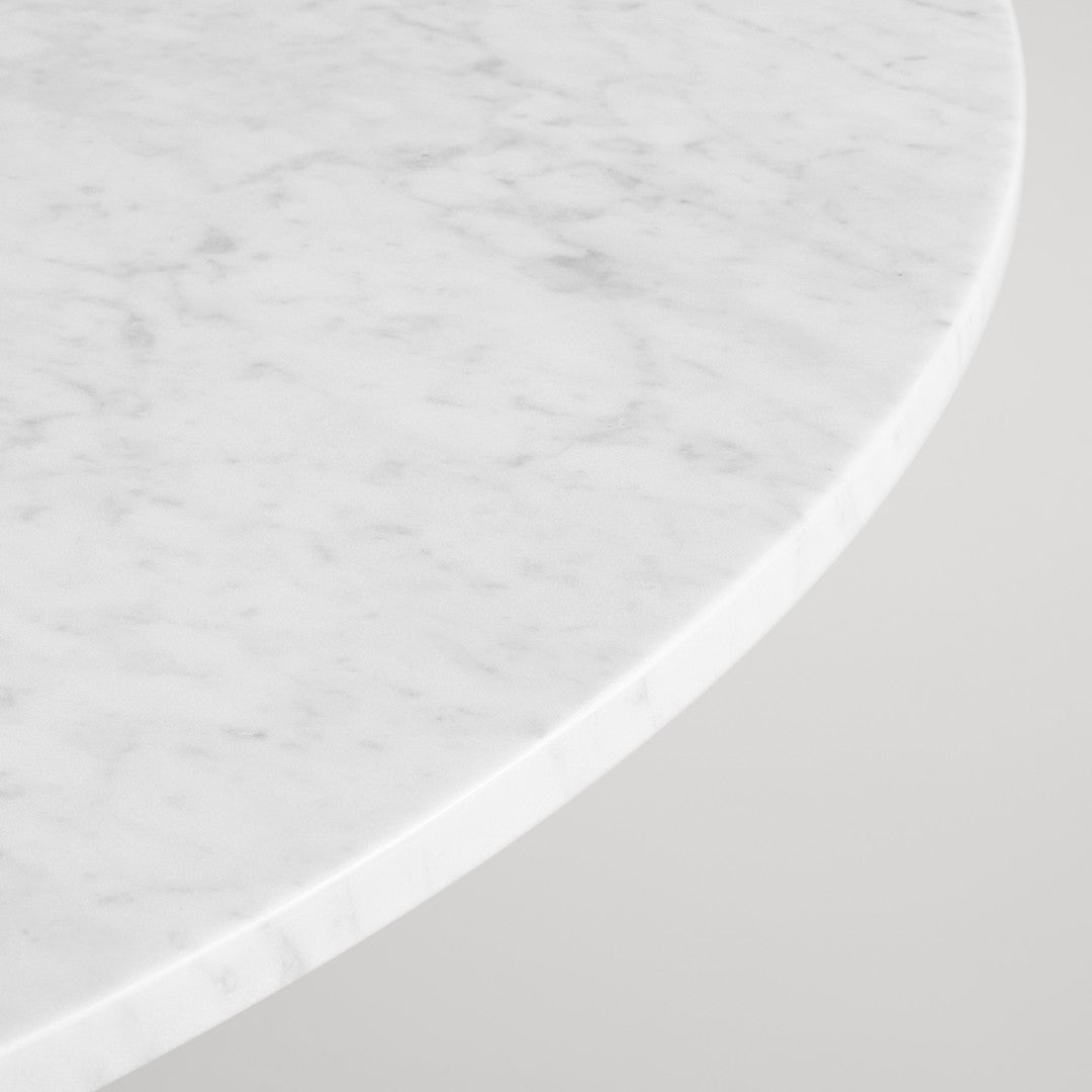 White marble tabletop with subtle gray veining and a smooth edge. Elegant and modern design.
