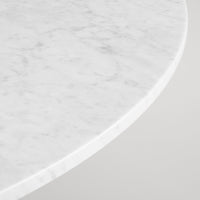 White marble tabletop with subtle gray veining and a smooth edge. Elegant and modern design.