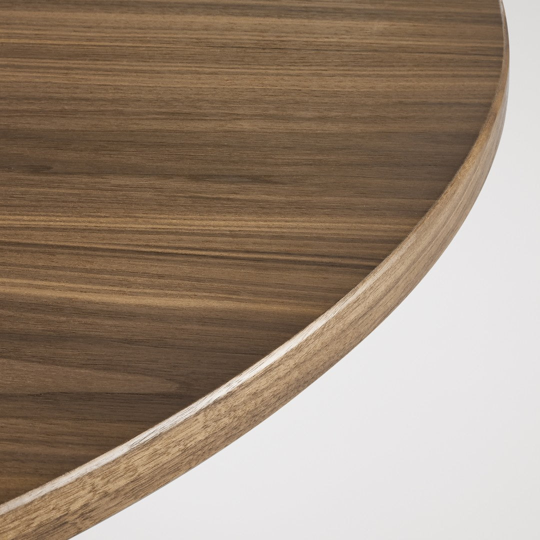 Brown wood grain table surface with subtle stripes and a smooth rounded edge.