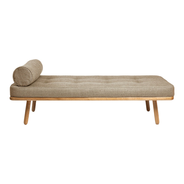 Tan tufted chaise lounge with bolster cushion and natural wood legs. Minimalist design for modern interiors.