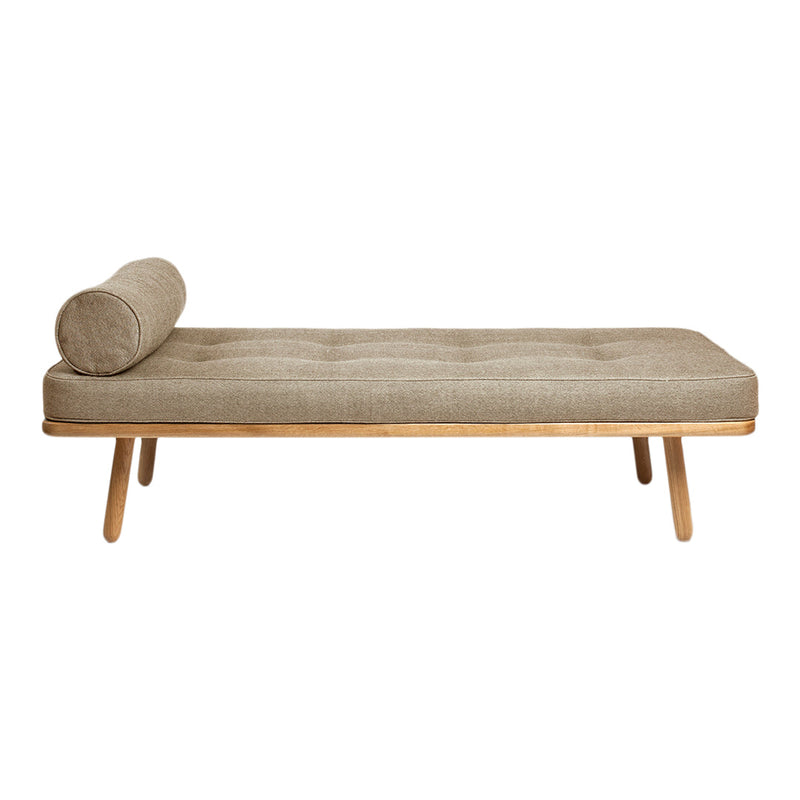 Tan tufted chaise lounge with bolster cushion and natural wood legs. Minimalist design for modern interiors.
