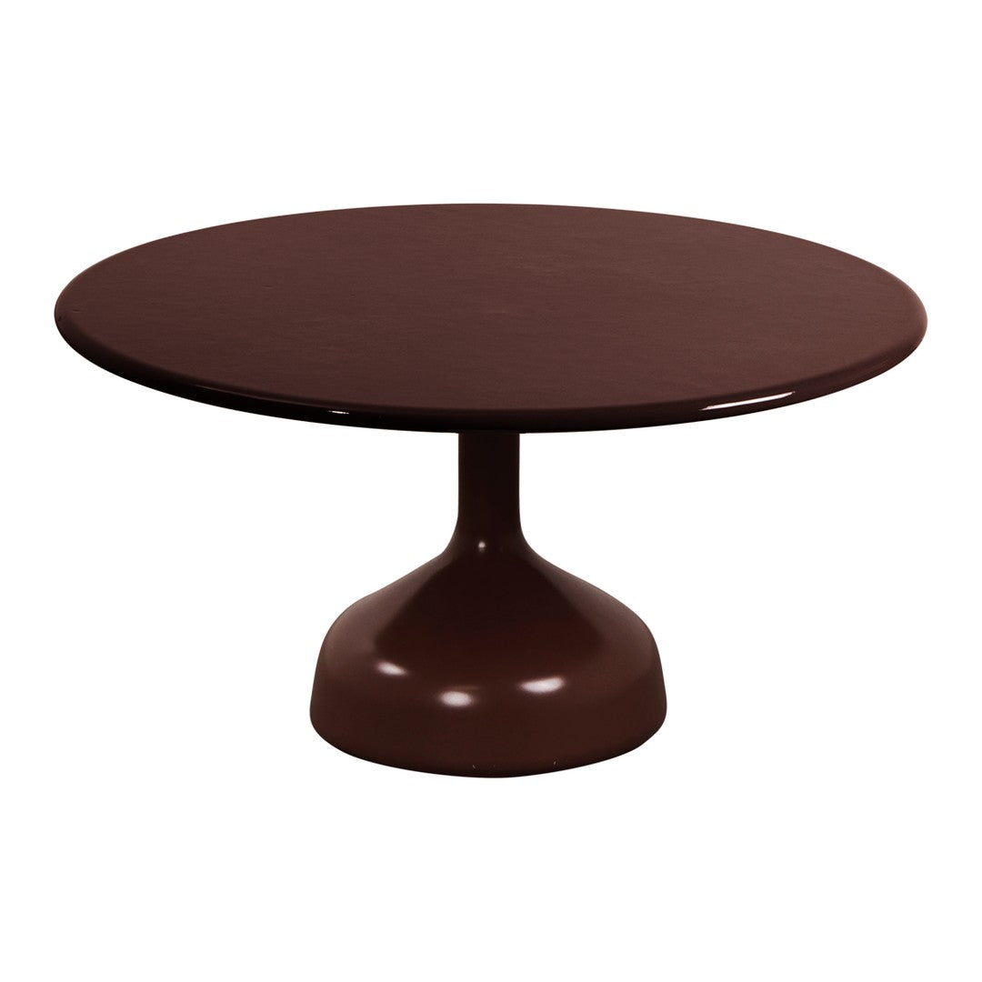 Round, glossy brown dining table with a sleek pedestal base, perfect for modern interiors.