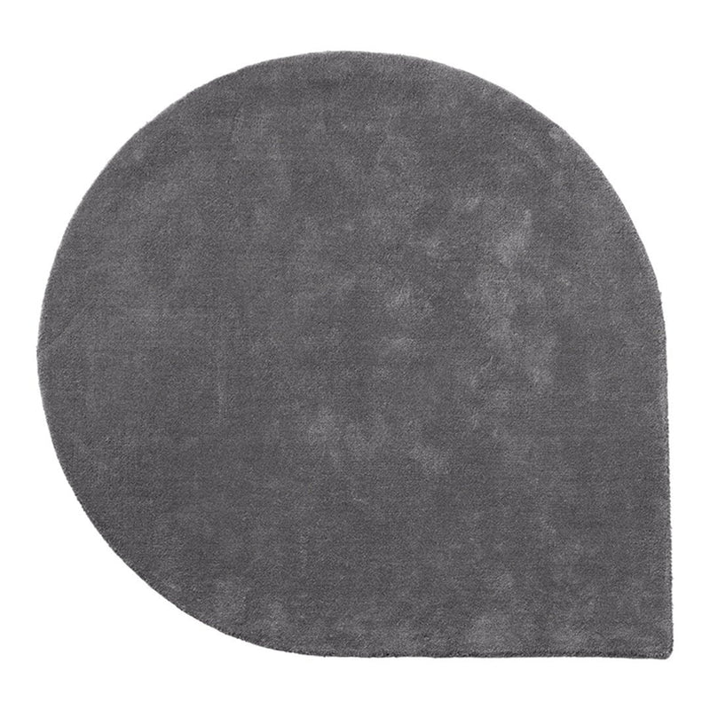 "Solid gray round rug with a unique half-moon design and soft textured finish."