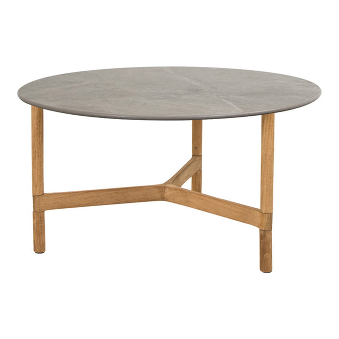 Round coffee table with a smooth gray top and natural wood legs, showcasing a minimalist design.