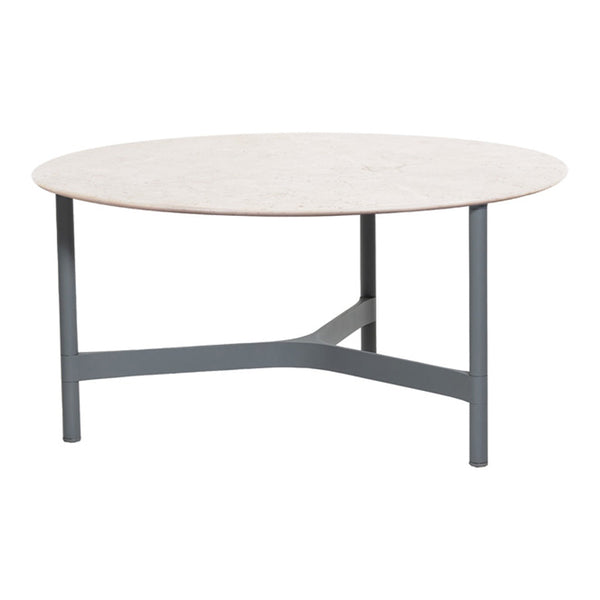 Round coffee table with a light beige top and dark gray metal legs, featuring a sleek, modern design.