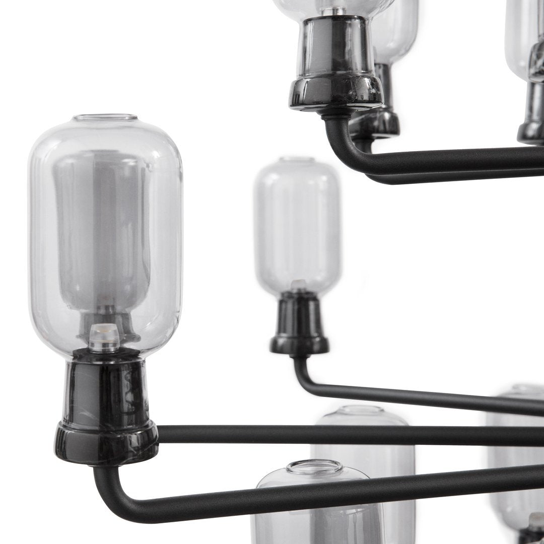 Glass bulb chandelier with black metal arms, showcasing a sleek, modern design and clear glass accents.